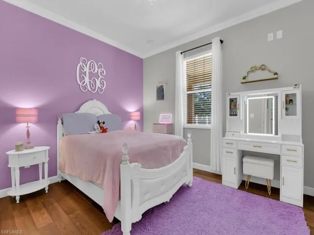 Bedroom featuring dark wood-type flooring and ornamental molding