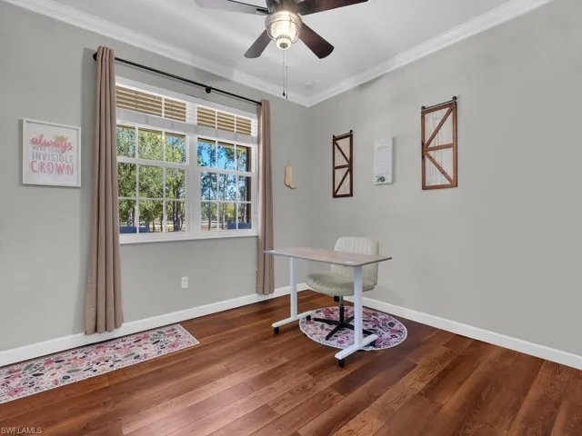 Office featuring dark wood-style flooring, crown molding, and ceiling fan
