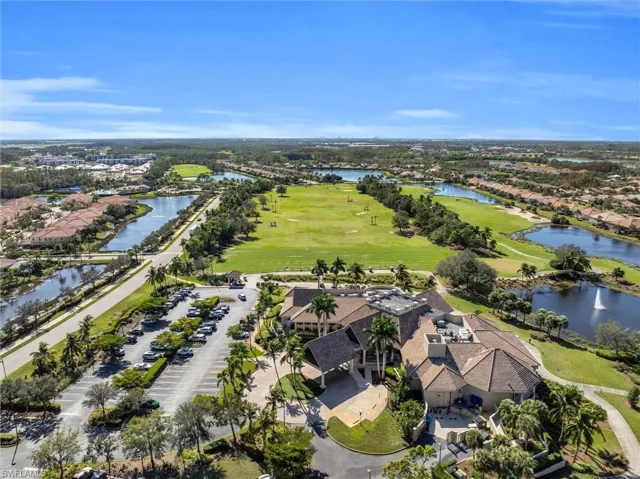 View of property location with a local golf course, a large body of water, and nearby suburban area
