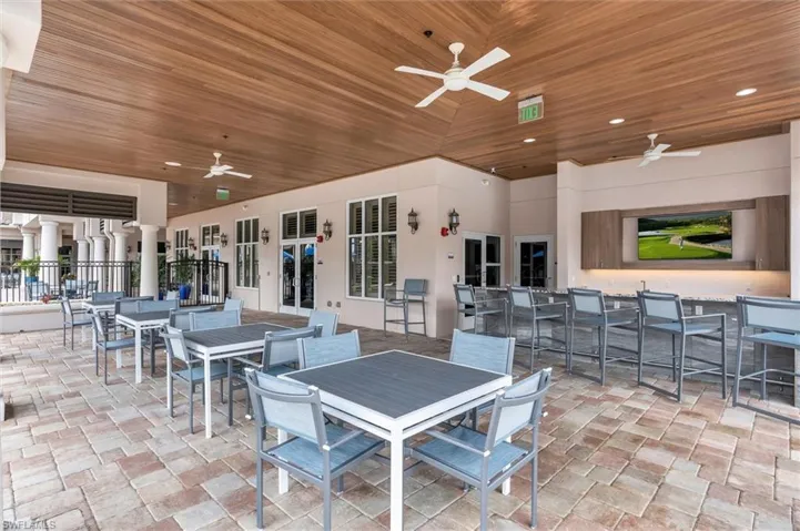 View of patio with ceiling fan and outdoor dining space