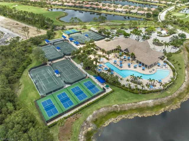 Bird's eye view of a nearby body of water and a pool