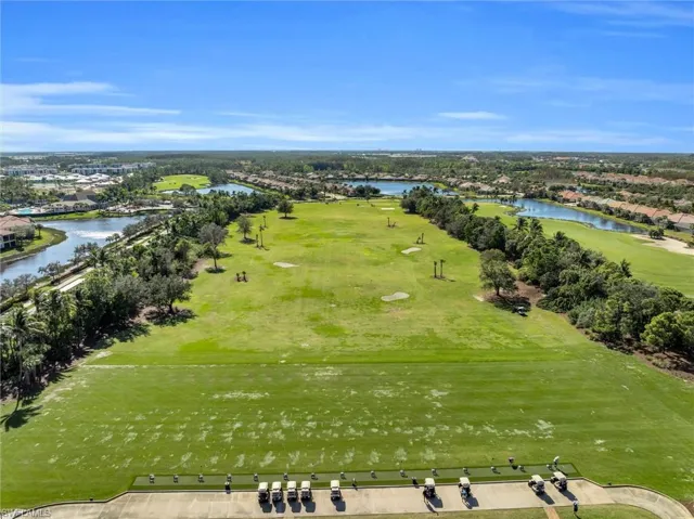 Aerial view of residential area with a nearby body of water and a golf club