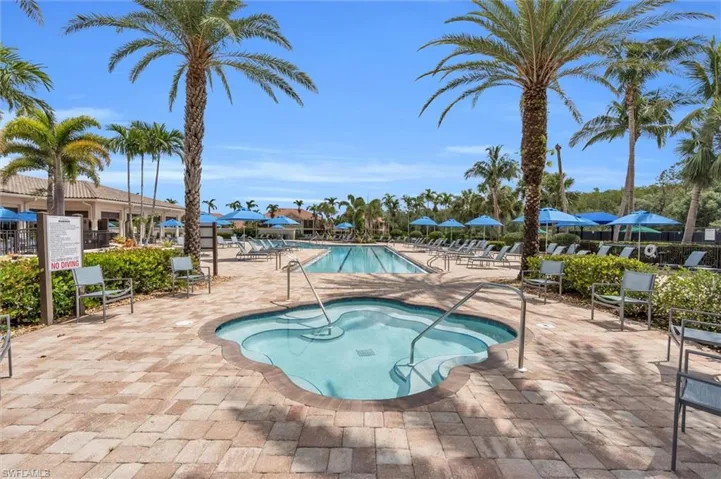 Community pool featuring a hot tub and a patio area