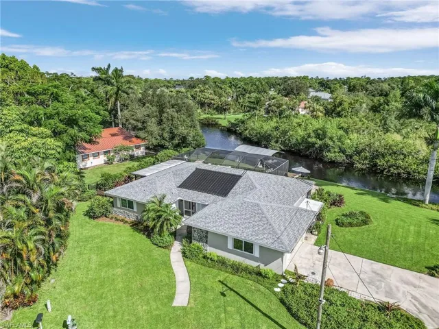Birds eye view of property with a water view