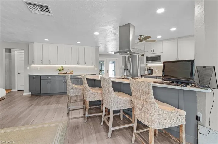 Two-tone cabinetry and breakfast bar area.