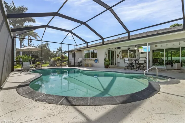 View of swimming pool and extra tall screen.