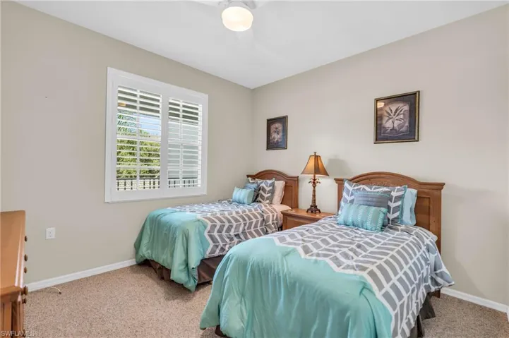 Bedroom featuring ceiling fan and light carpet