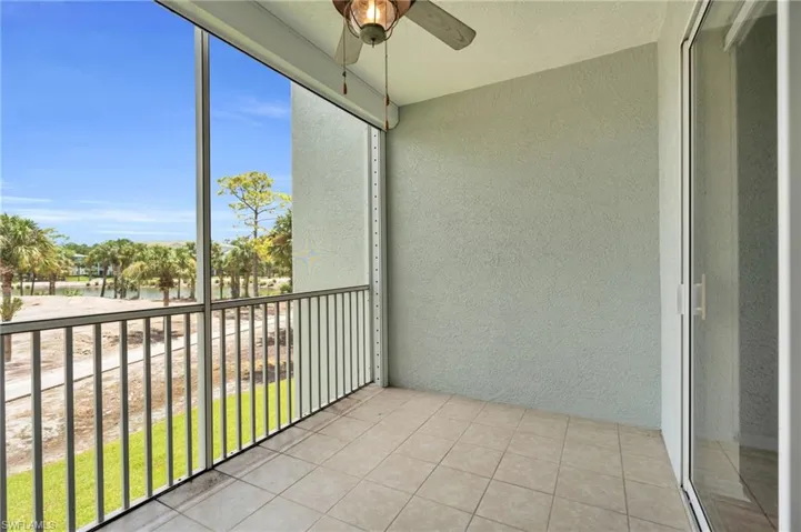 Unfurnished sunroom featuring ceiling fan