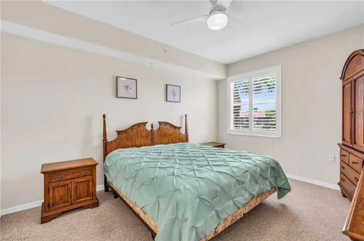 Carpeted bedroom with ceiling fan