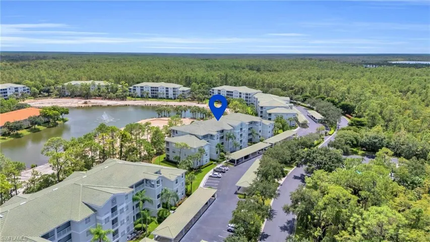 Birds eye view of property with a water view