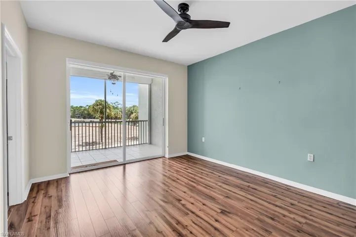 Spare room with hardwood / wood-style floors and ceiling fan