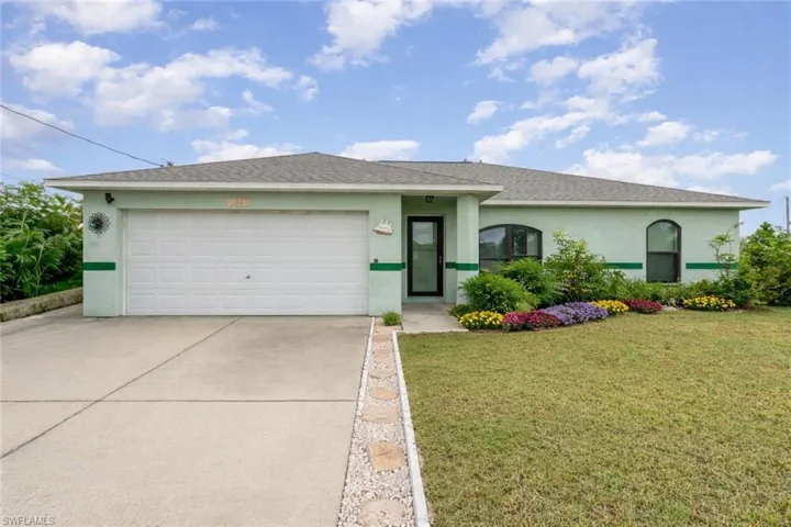 Single story home with a garage, a front yard, concrete driveway, stucco siding, and a shingled roof