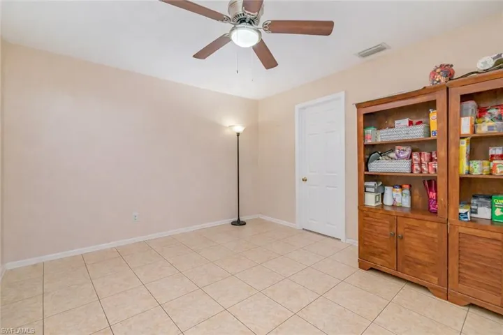Unfurnished room featuring a ceiling fan and light tile patterned floors