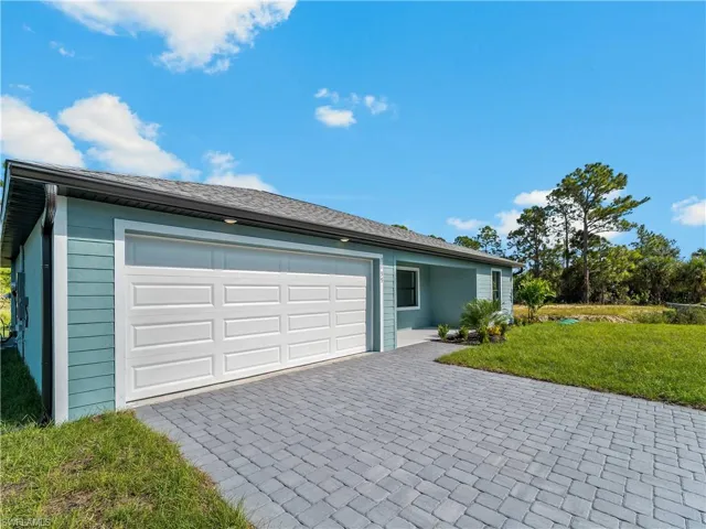 Garage featuring decorative driveway