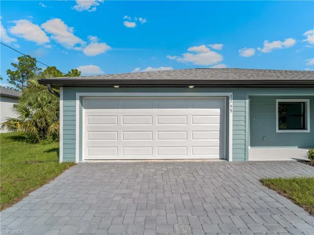 Garage featuring decorative driveway