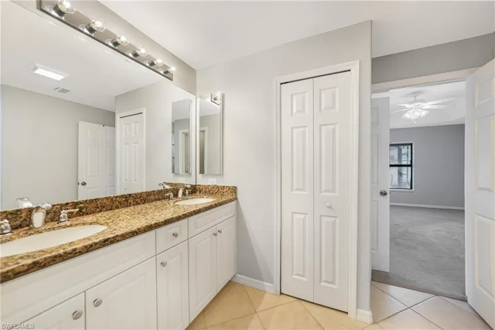 Bathroom featuring tile patterned floors, ceiling fan, and vanity
