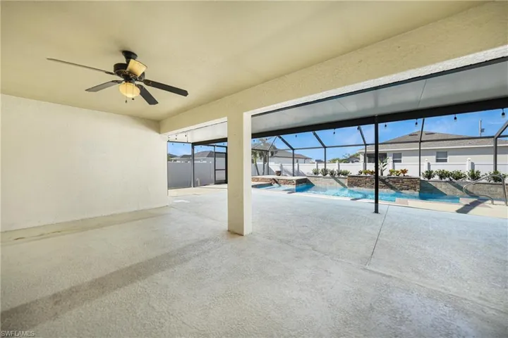 View of swimming pool with a lanai, ceiling fan, and a patio