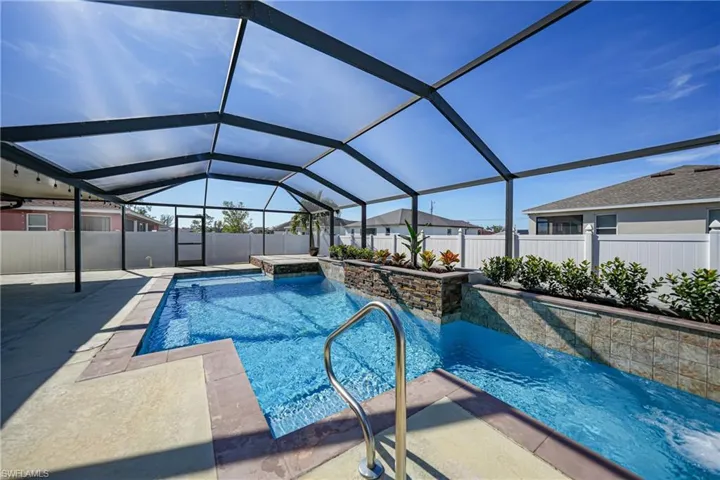 View of swimming pool with a lanai and a patio