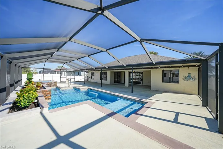 View of pool featuring ceiling fan, a lanai, and a patio