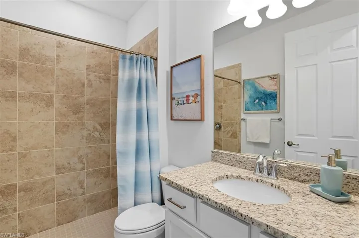 Bathroom with vanity and a tile shower