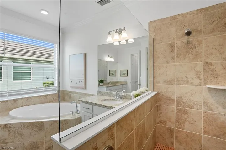 Full bath with walk in shower, a bath, vanity, and ornamental molding