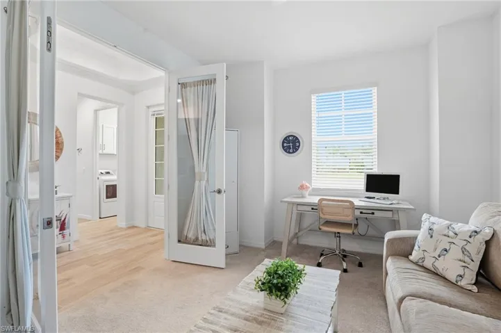 Office area featuring light carpet and washer / clothes dryer
