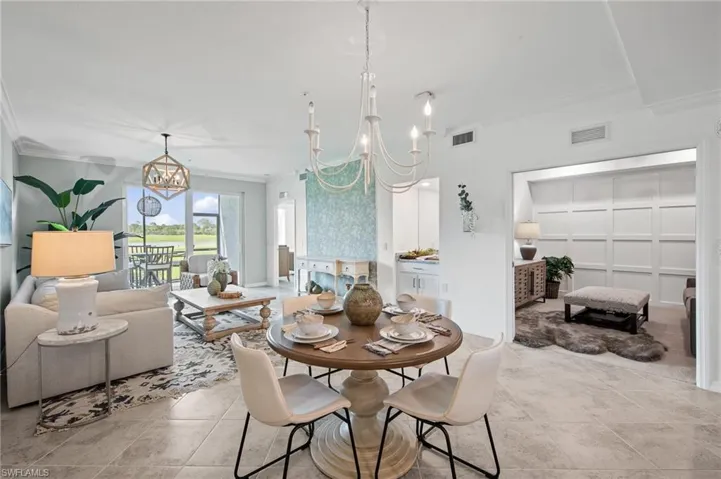 Dining room with a chandelier and ornamental molding