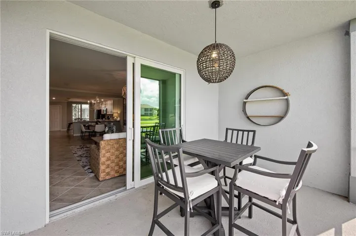 Dining area featuring a chandelier, a textured wall, and a textured ceiling
