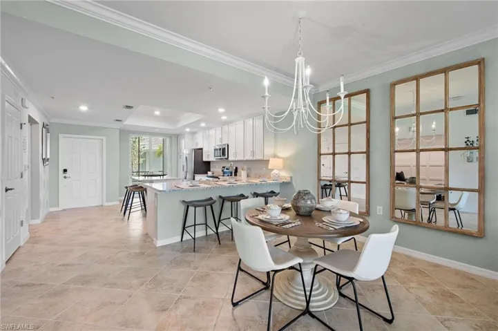 Dining space featuring a chandelier, crown molding, and recessed lighting