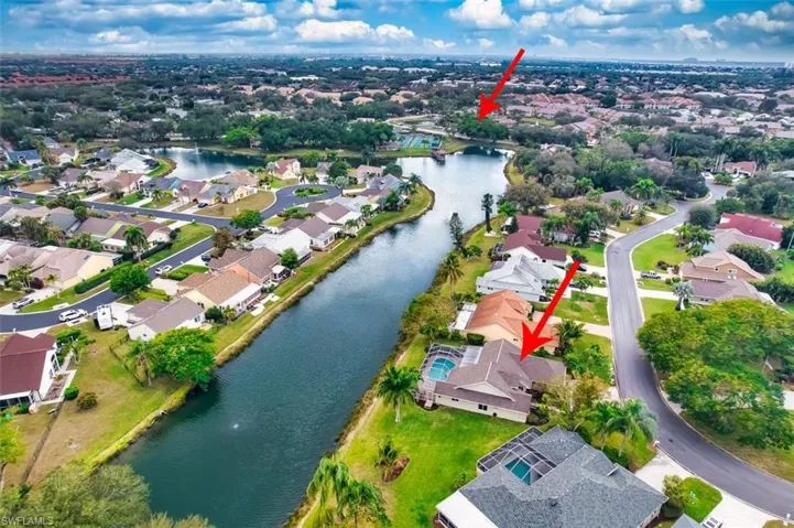 Aerial overview of property's location with a nearby body of water and nearby suburban area
