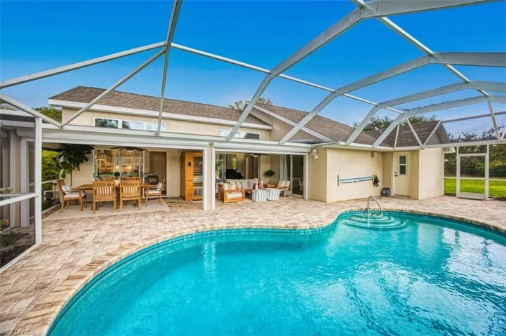 Back of property featuring a sunroom, stucco siding, a patio area, and a lanai