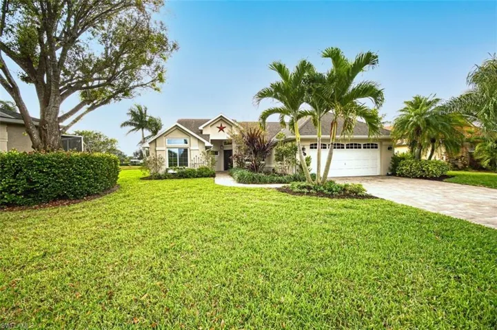 Single story home with decorative driveway, a front lawn, an attached garage, and stucco siding