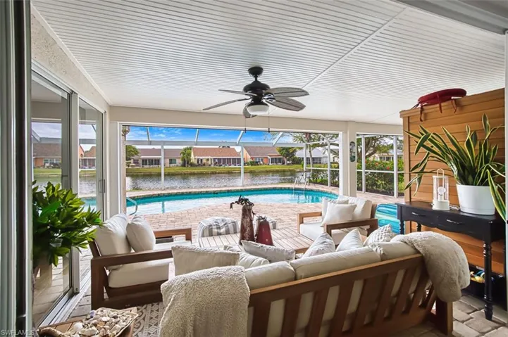 Outdoor pool with a sunroom, an outdoor living space, a residential view, and a patio