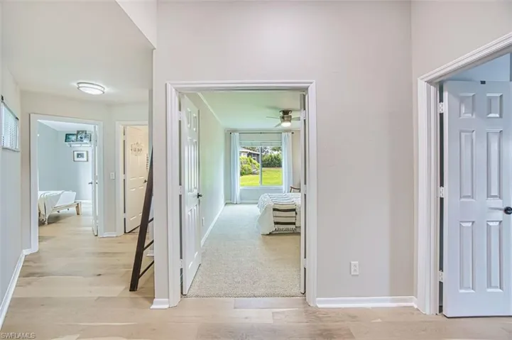 Hall featuring light wood-type flooring and baseboards