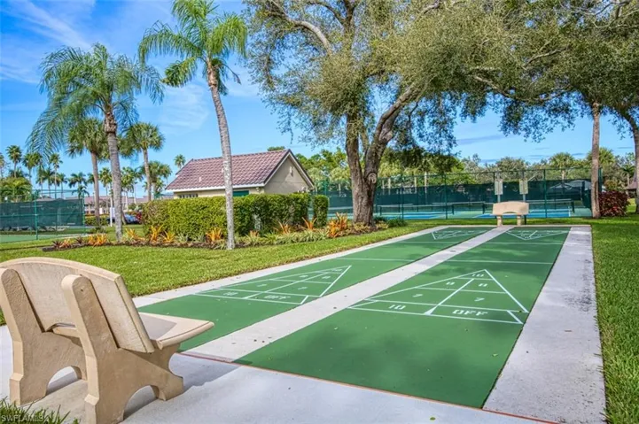Surrounding community with shuffleboard and a tennis court
