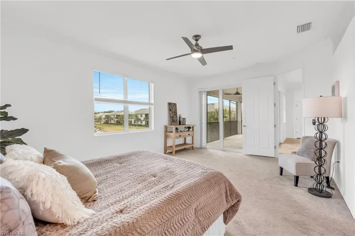 Carpeted bedroom with access to outside, ceiling fan, and crown molding
