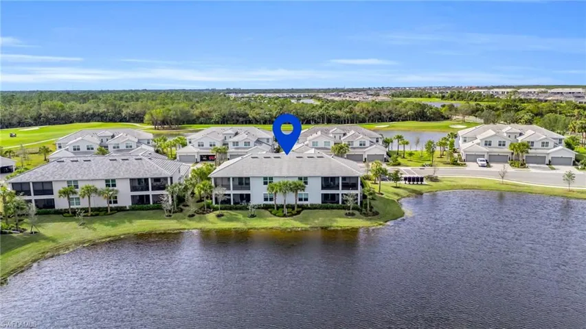 Birds eye view of property with a water view