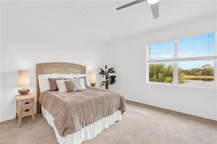 Bedroom featuring ceiling fan and light carpet