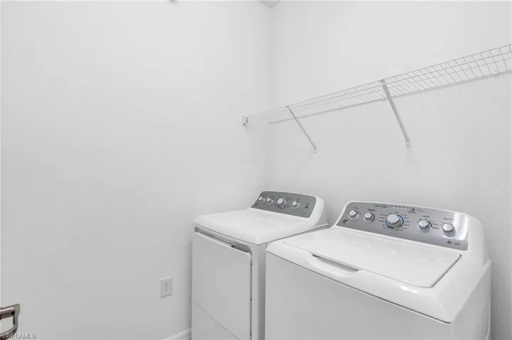 Washroom with washing machine and clothes dryer