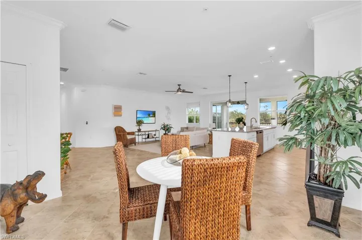 Dining room with ceiling fan, sink, and crown molding