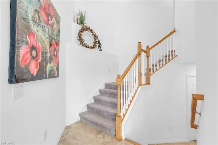 Stairway featuring tile patterned floors