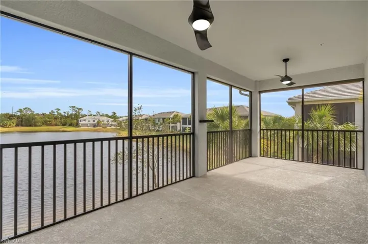 Sunroom featuring a water view