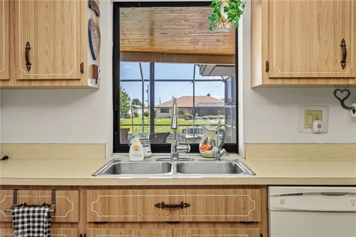 Kitchen sink with a dual basin, stainless steel faucet, and a neutral countertop