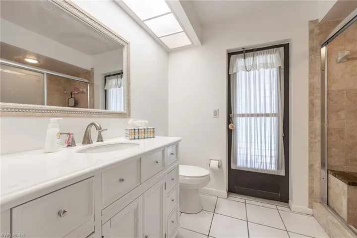 White vanity with an integrated sink and brushed nickel faucet