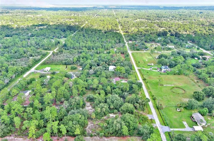 Aerial overview of property's location featuring a heavily wooded area and rural landscape