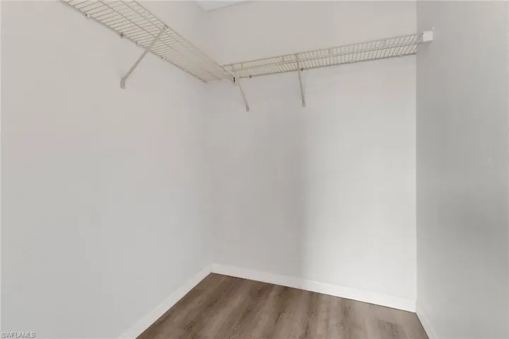 Walk in closet featuring dark hardwood / wood-style flooring