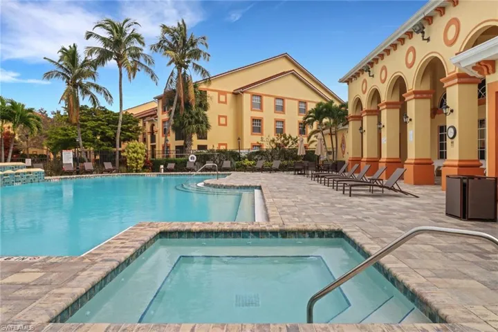 View of pool with a hot tub and a patio area