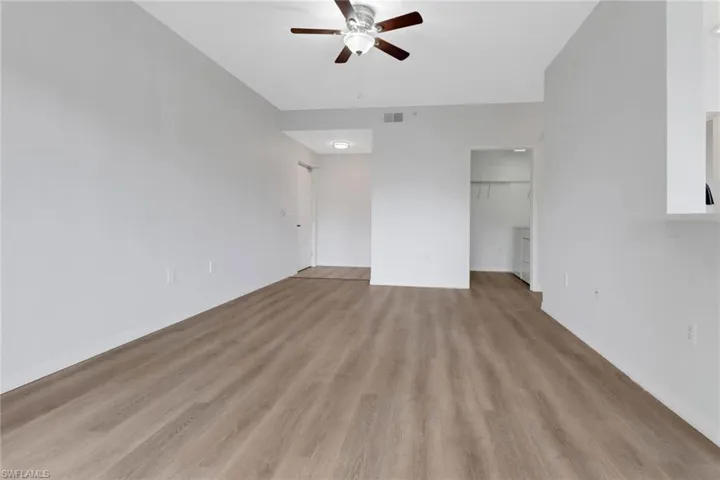 Unfurnished living room with light hardwood / wood-style flooring and ceiling fan