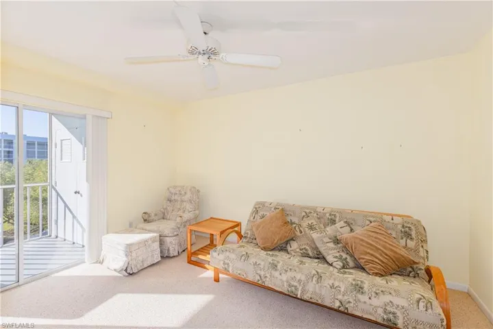 Living area with carpet and ceiling fan