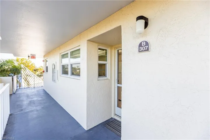 View of exterior entry with a balcony